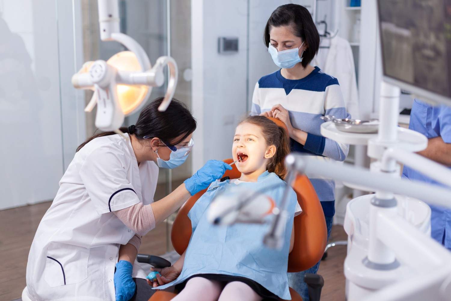 Female dentist and cute little