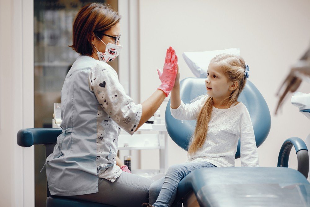 girl sitting in the dentists office